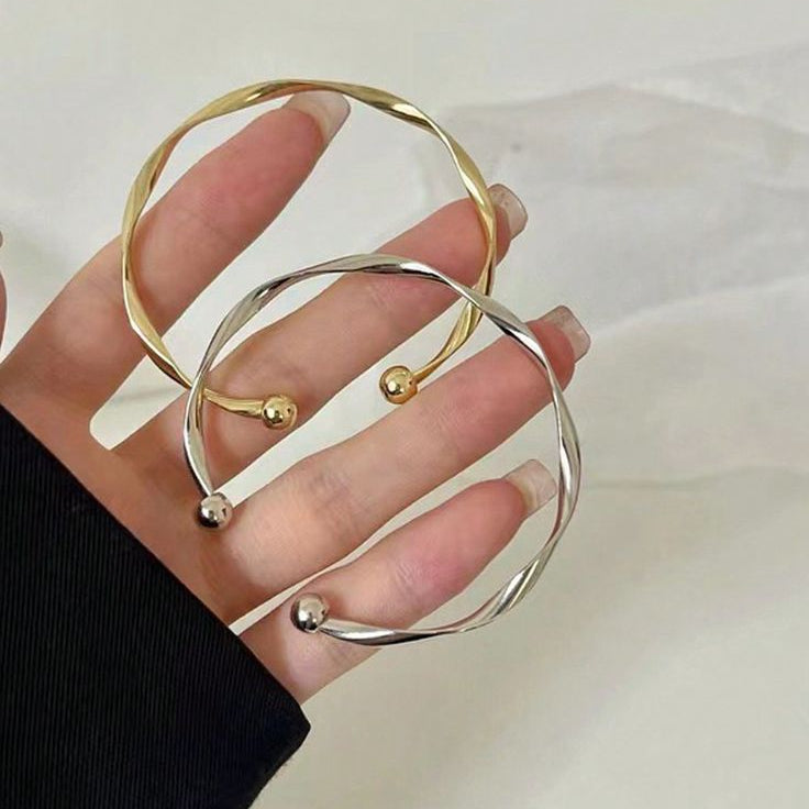 The Helix Horizon: Sculptural Twisted Bangle Duo