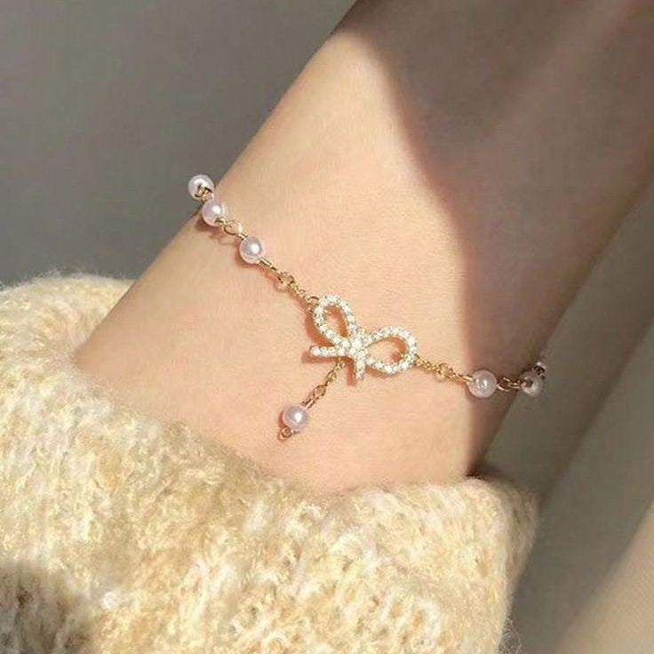 The Papillon Perle: Gilded Pavé Bow & Cascading Pearl Bracelet